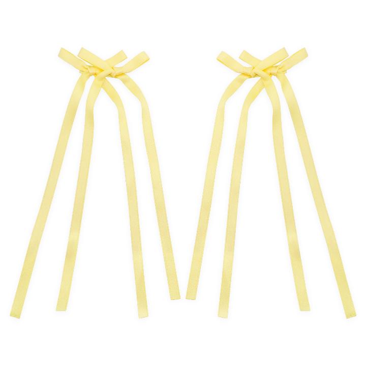 Light yellow bow ribbon hair clip with a soft, delicate design, perfect for adding a subtle pop of color to any hairstyle.