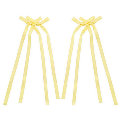 Light yellow bow ribbon hair clip with a soft, delicate design, perfect for adding a subtle pop of color to any hairstyle.