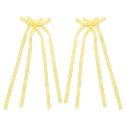 Light yellow bow ribbon hair clip with a soft, delicate design, perfect for adding a subtle pop of color to any hairstyle.